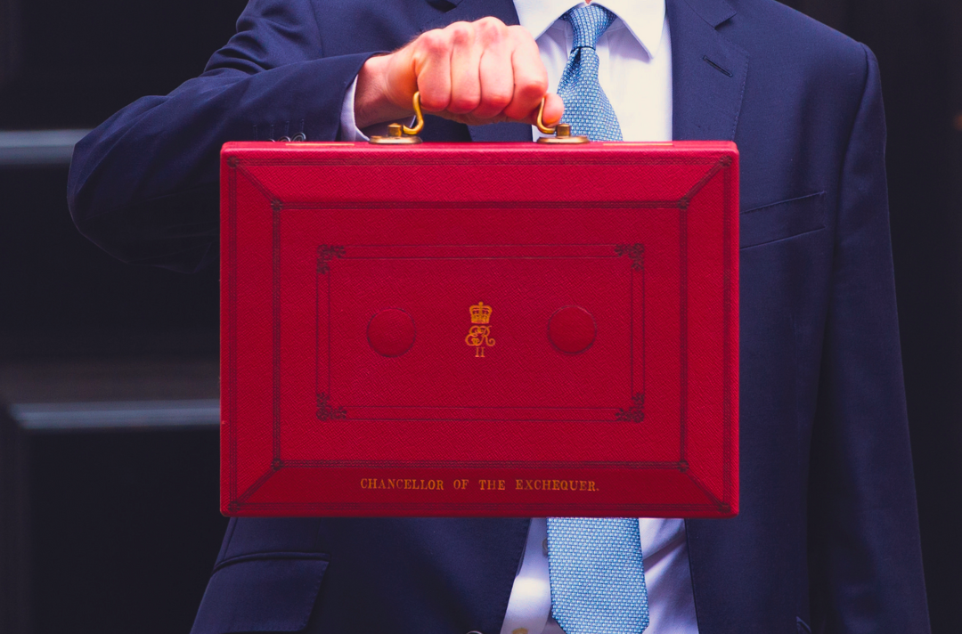 Photo shows someone holding out a government red box.