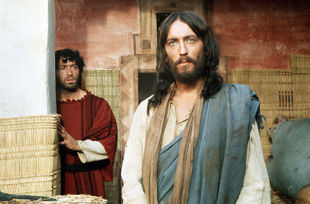 Photo shows Jesus standing and looking past the camera. ‘Jesus of Nazareth’ (1977) Streaming now on ITVX