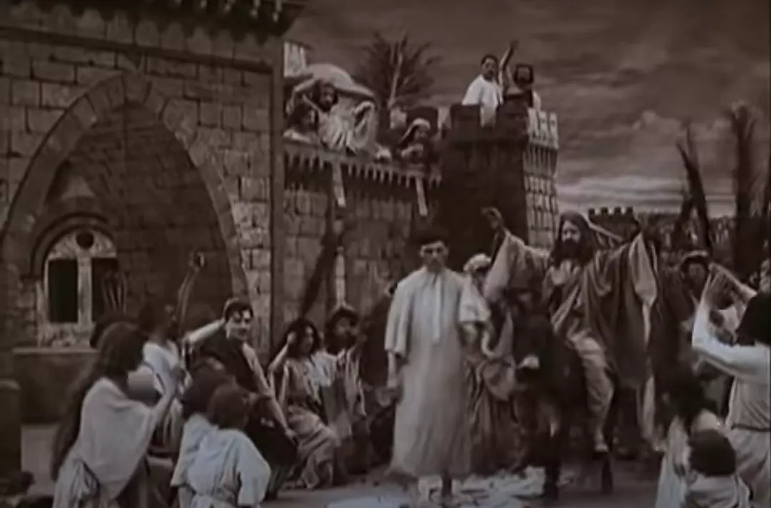 Photo shows Jesus riding a donkey surrounded by people worshipping him. ‘La Vie et la Passion de Christ’ (1903)