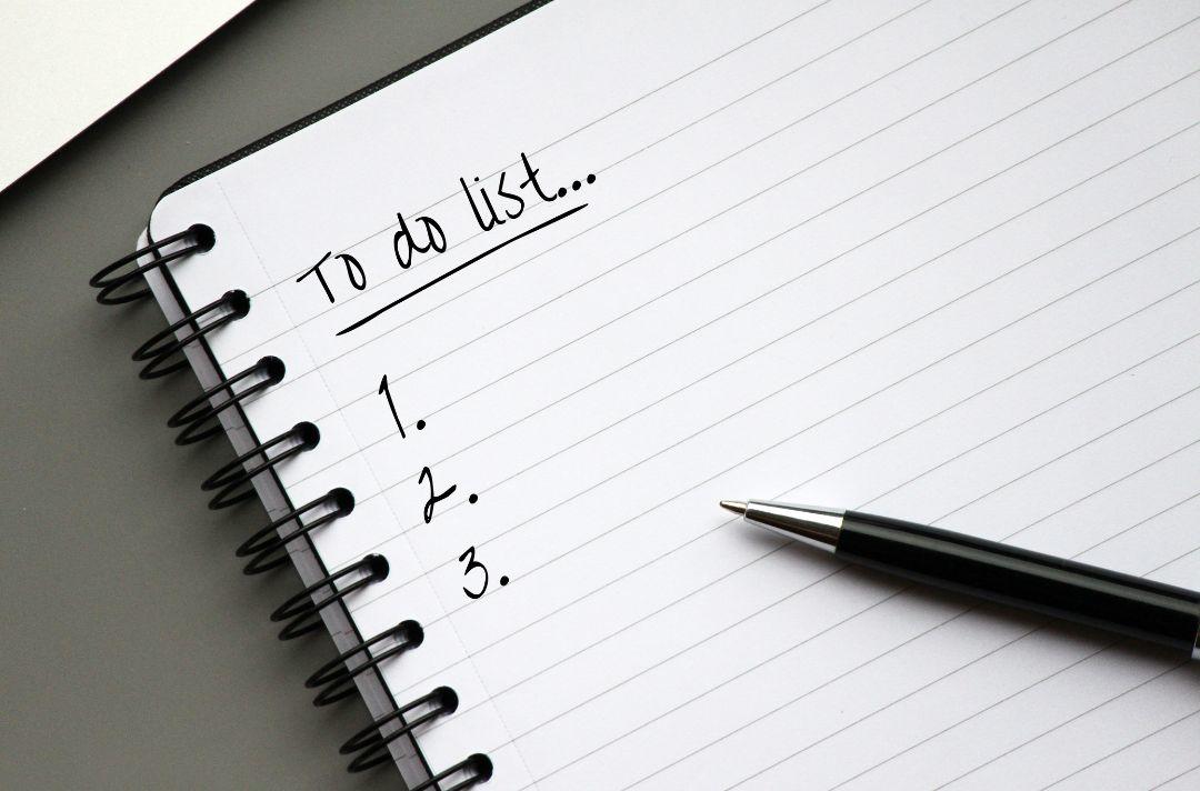 A photo of a pad of paper with the words 'To do list' written in ink with a 1,2,3 list left to fill in.