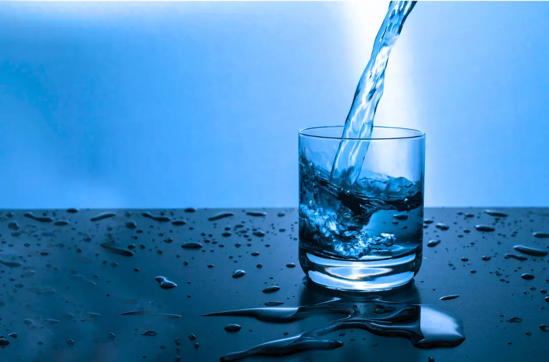 Photo shows a glass being filled with water.