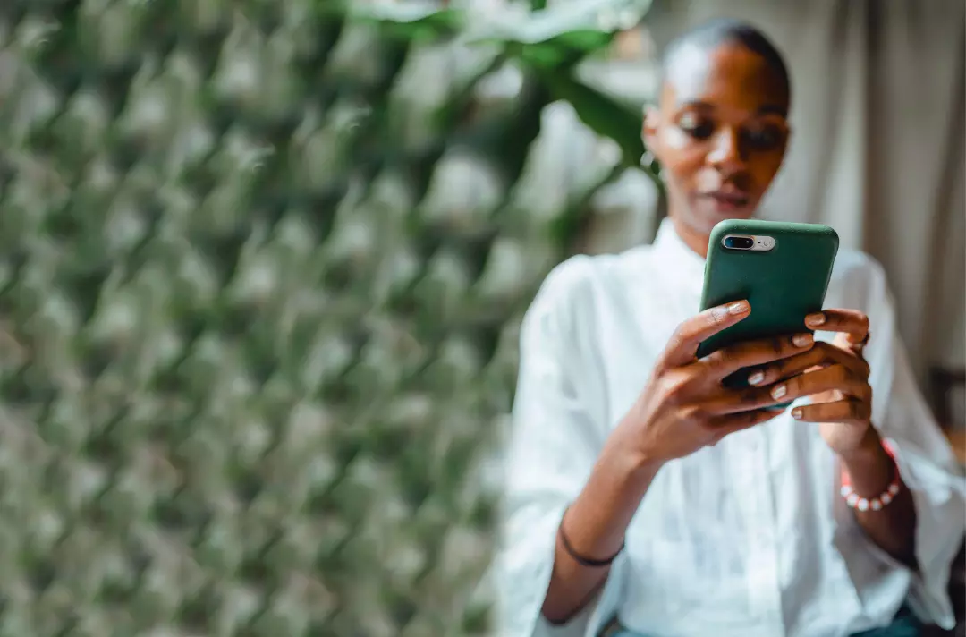 Photo shows someone typing on a mobile phone.