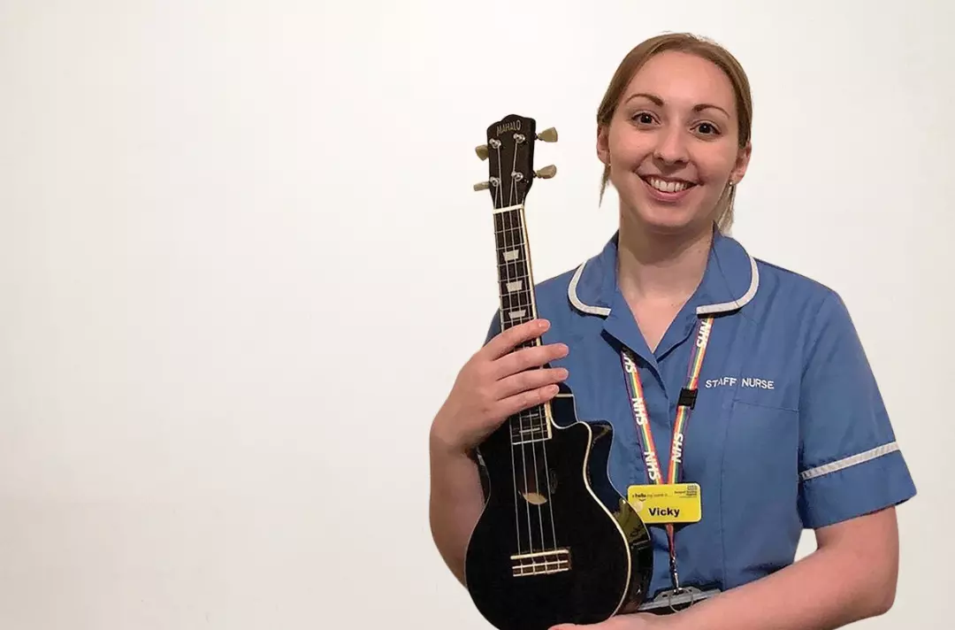 Photo of Vicky Gate holding a ukulele.