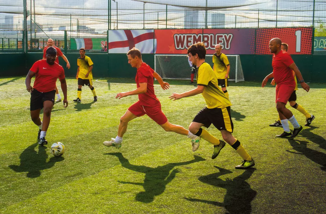 A photo shows someone going for a tackle during a game of football.