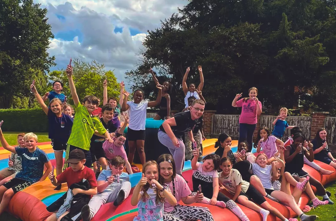 A photo shows members of the South West junior camp smiling for a group photo.