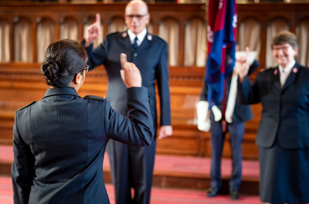 A photo from behind shows a cadet saluting in front of the Principal and Territorial Commander.