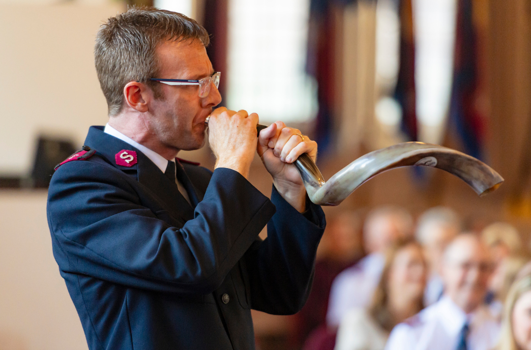A photo shows Captain Ian Standley playing the shofar.