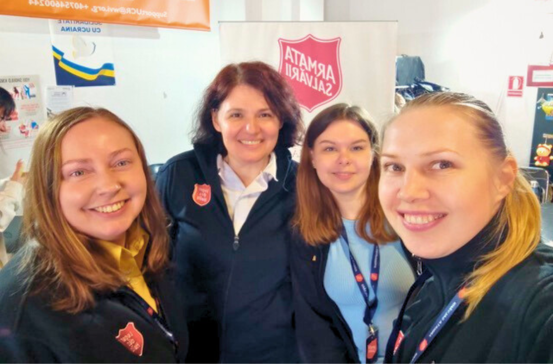 A photo shows Galina Korenivska and three volunteers smiling at the camera.