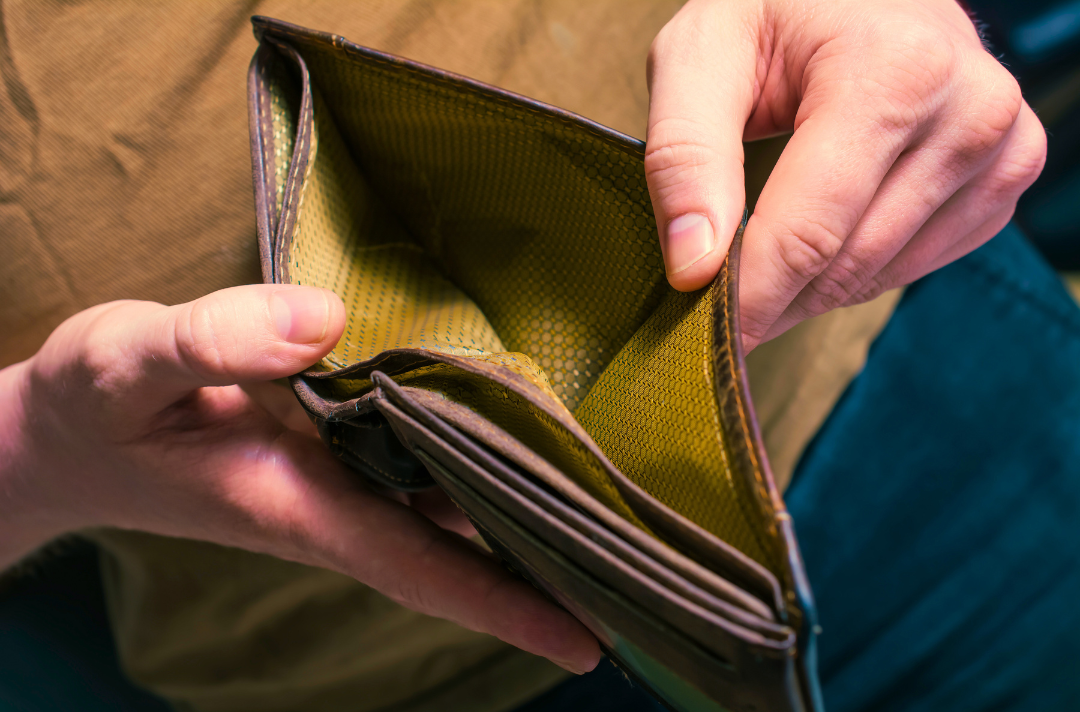A photo shows someone opening an empty wallet.