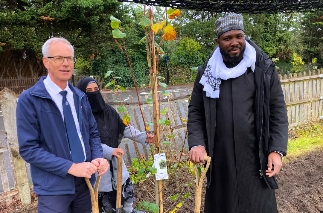 Photo shows Lieut-Colonel Jonathan Roberts with Fatima and Imam Abdul Hasiz.