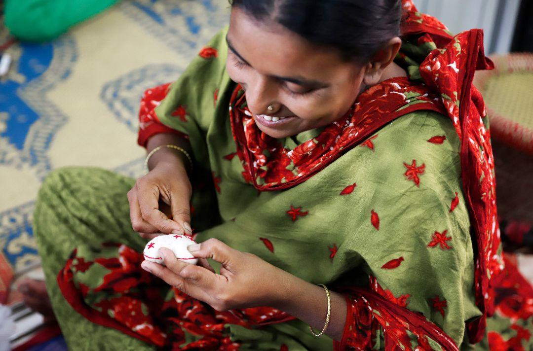 A photo of a woman from Bangladesh making heart baubles