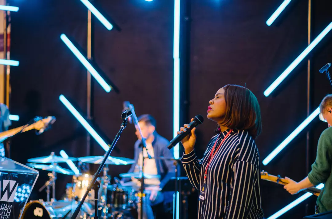 A photo shows people leading worship.