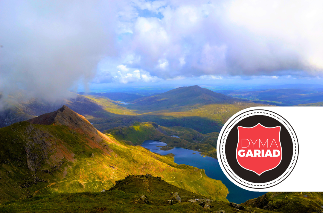 A photo shows Welsh countryside. A red shield displays the text 'Dyma Gariad'.