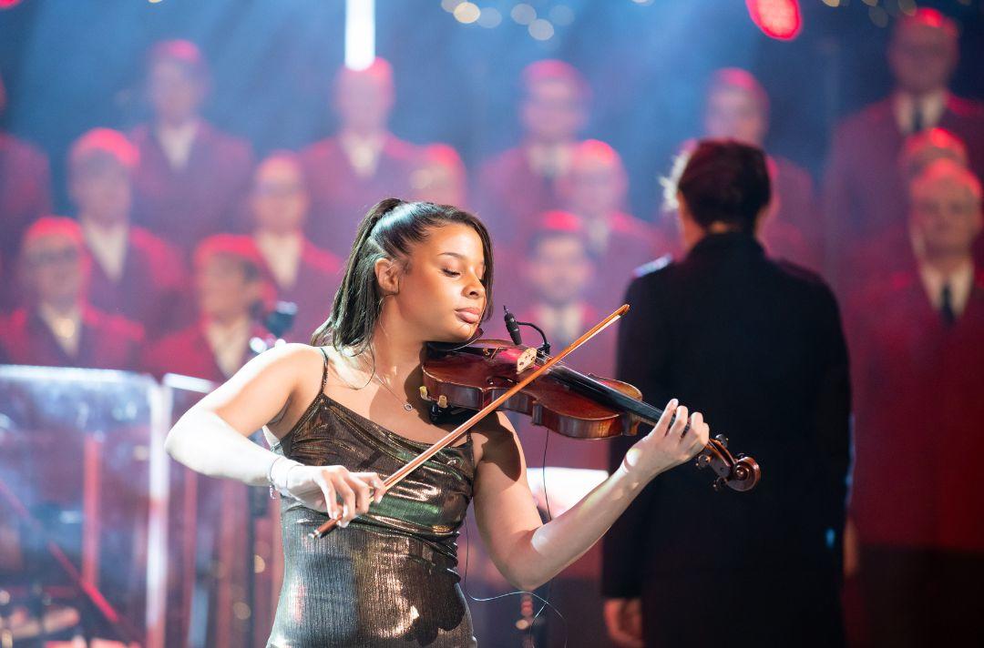 A photo of Caitlin Kisumb playing the violin on stage of the Royal Albert Hall