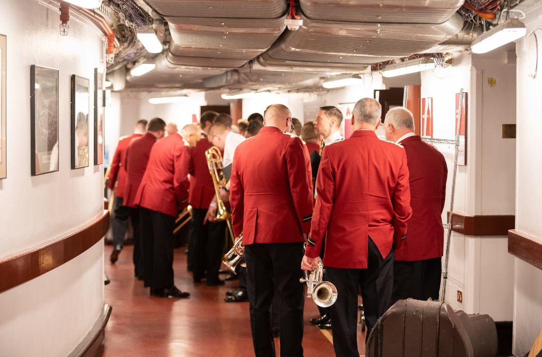 A photo of Salvation Army brass musicians waiting to go on stage with their instruments at the Royal Albert Hall