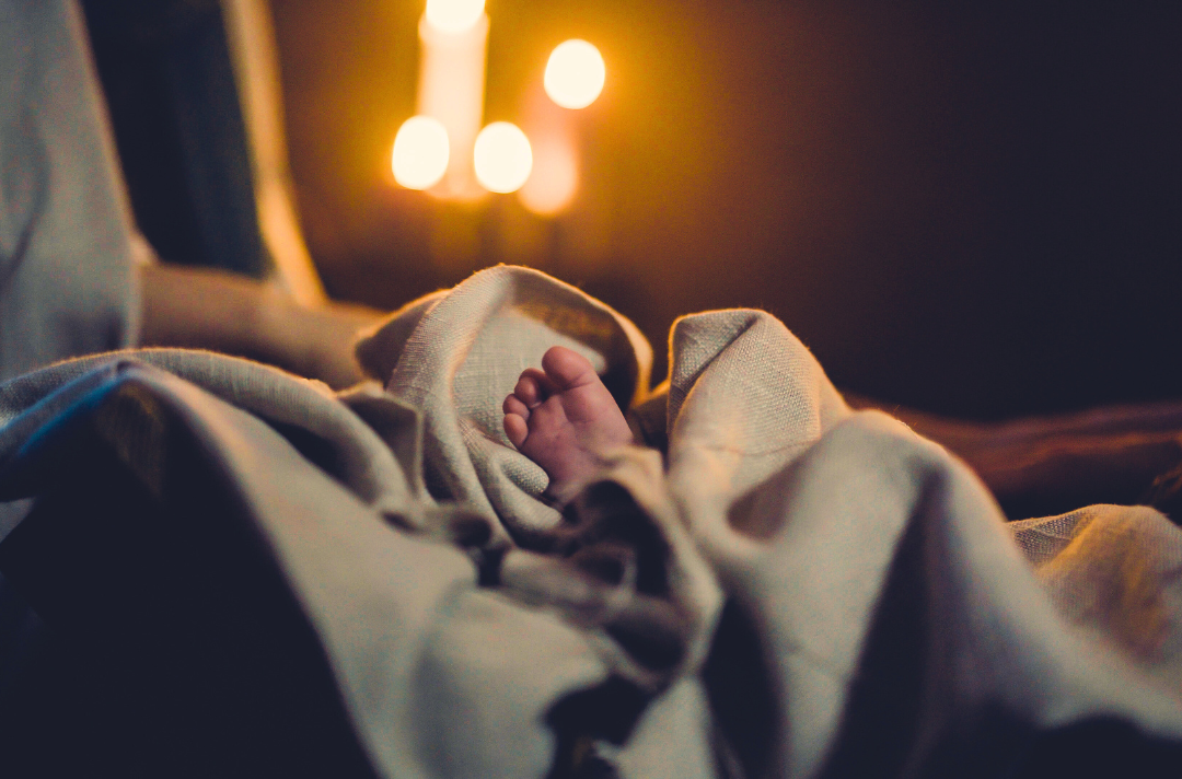 A photo shows baby Jesus' foot sticking out of blankets.