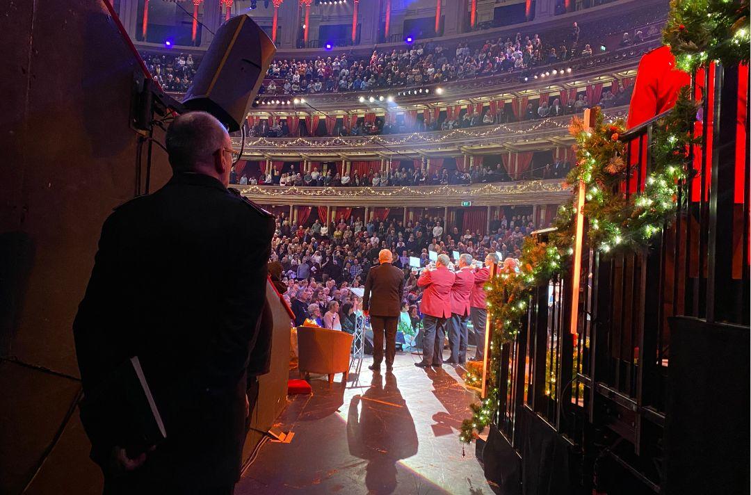 A photo from the wings of the Royal Albert Hall looking out into the auditorium during the singing of the final carol