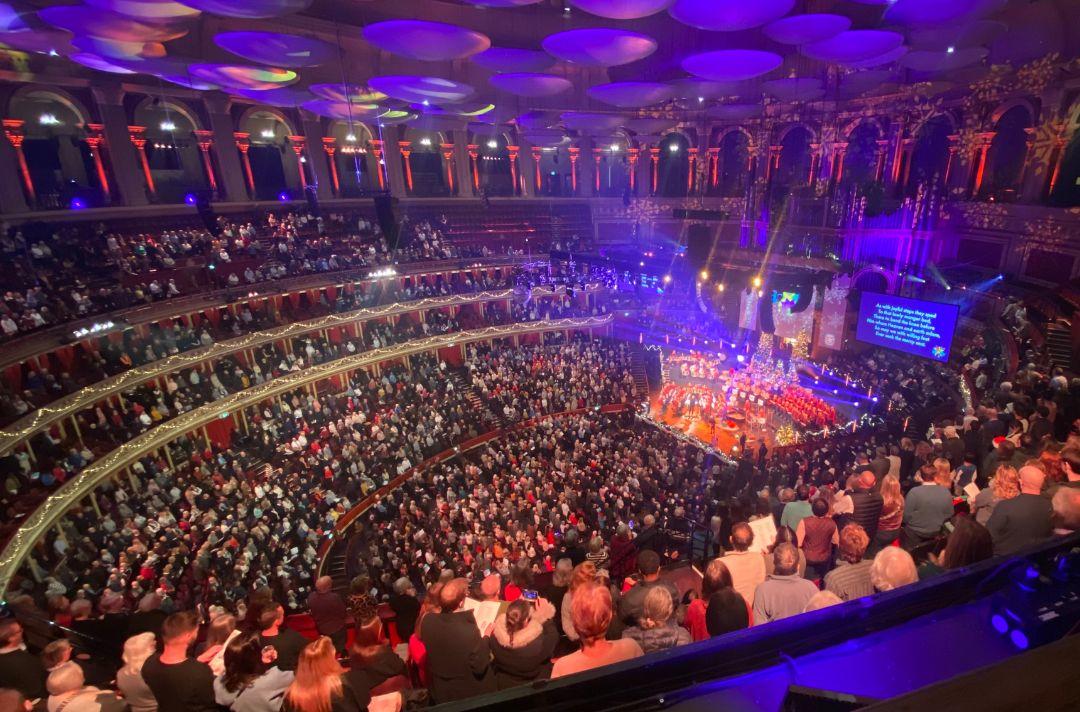 A photo of the full auditorium from the gallery of the Royal Albert Hall during the singing of a carol