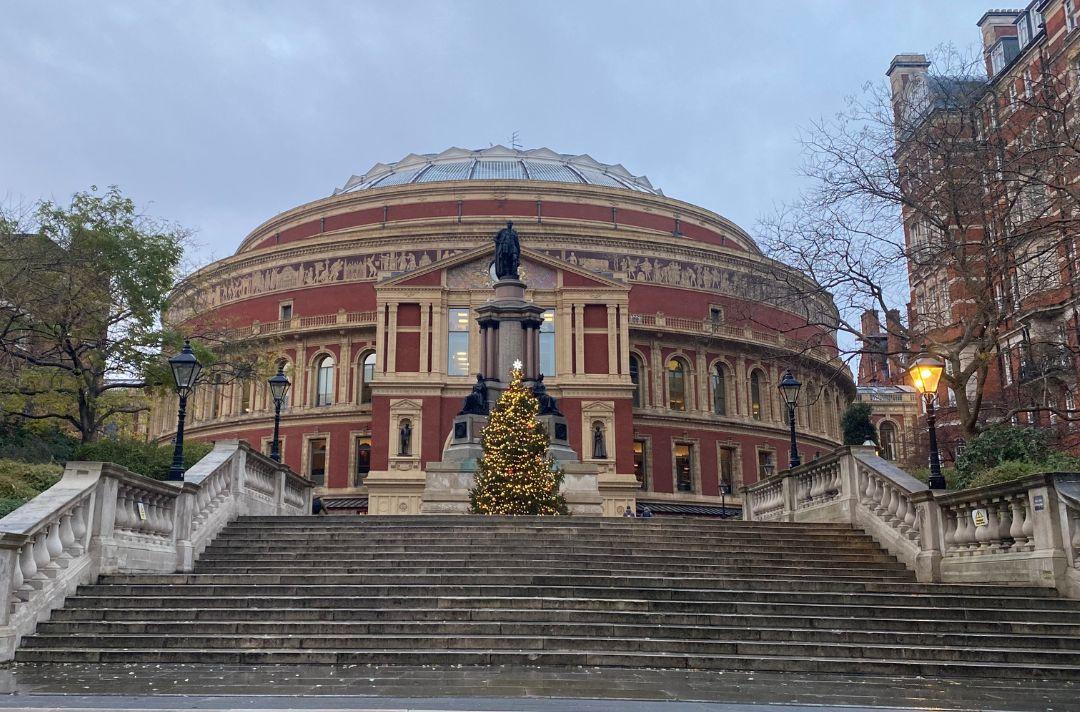 A photo of the Royal Albert Hall with a Christmas tree in front of it