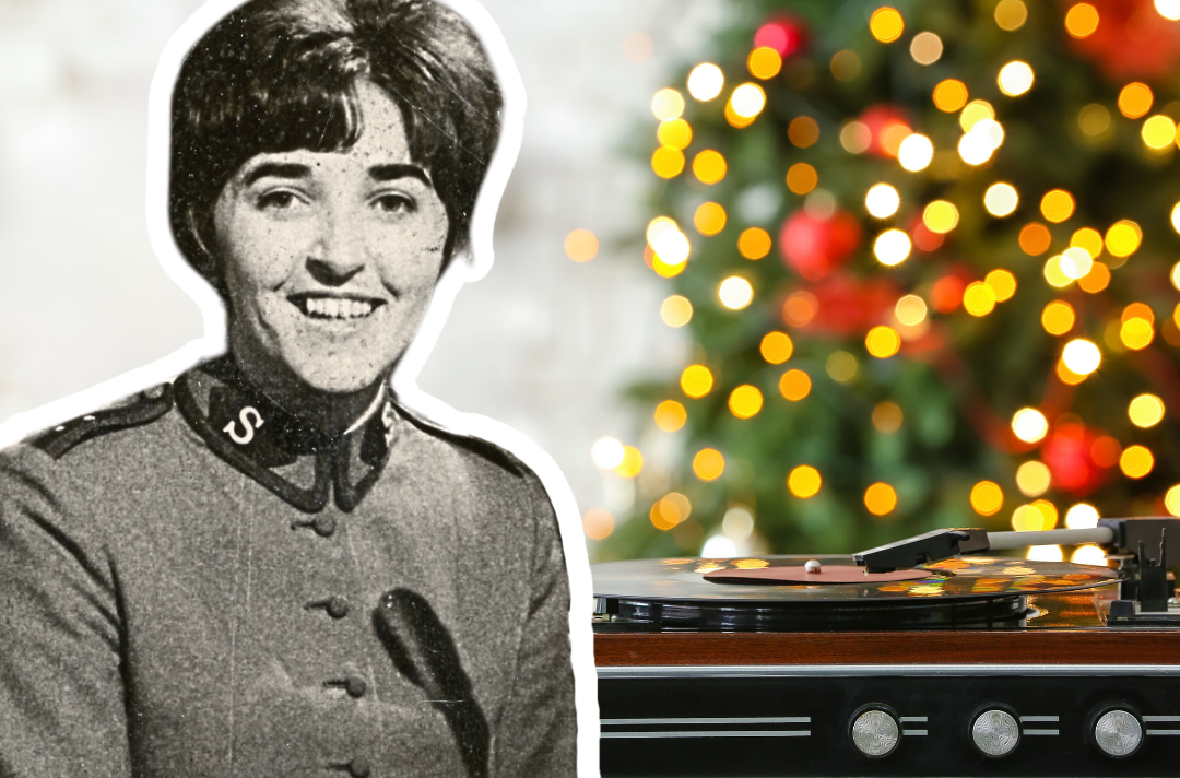 A photo shows a cut-out of Major Joy Webb. Behind the cut-out is a record player with a Christmas tree out of focus in the background.