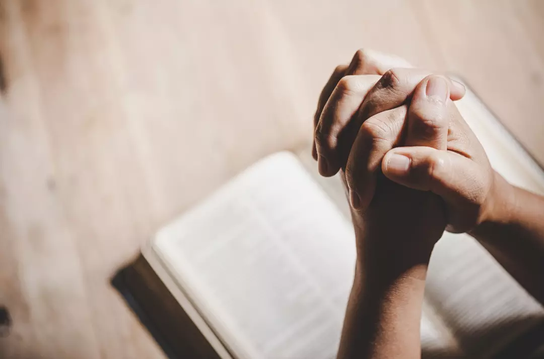 A photo of praying hands