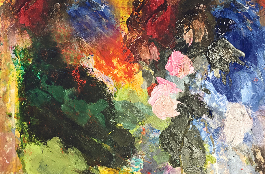 Photo shows a messy paint palette covered in vibrant colours.
