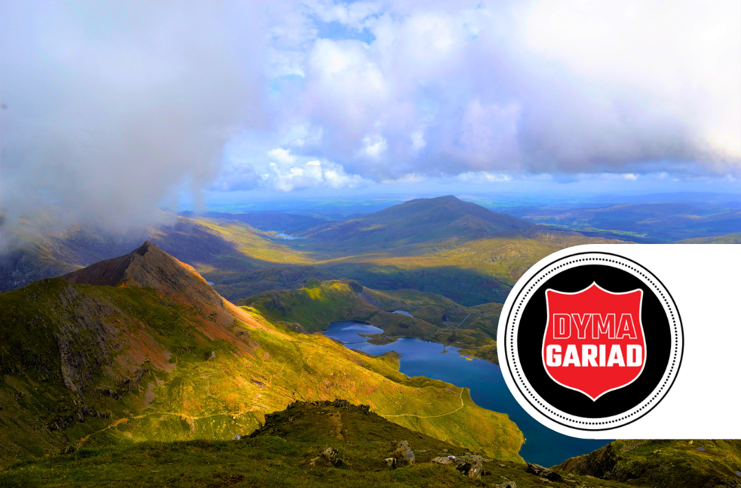 A photo of Welsh countryside with the Dyma Gariad logo