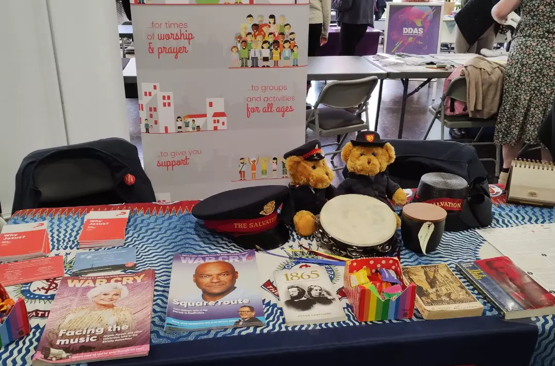 A photo shows a table laid out with Salvation Army materials.