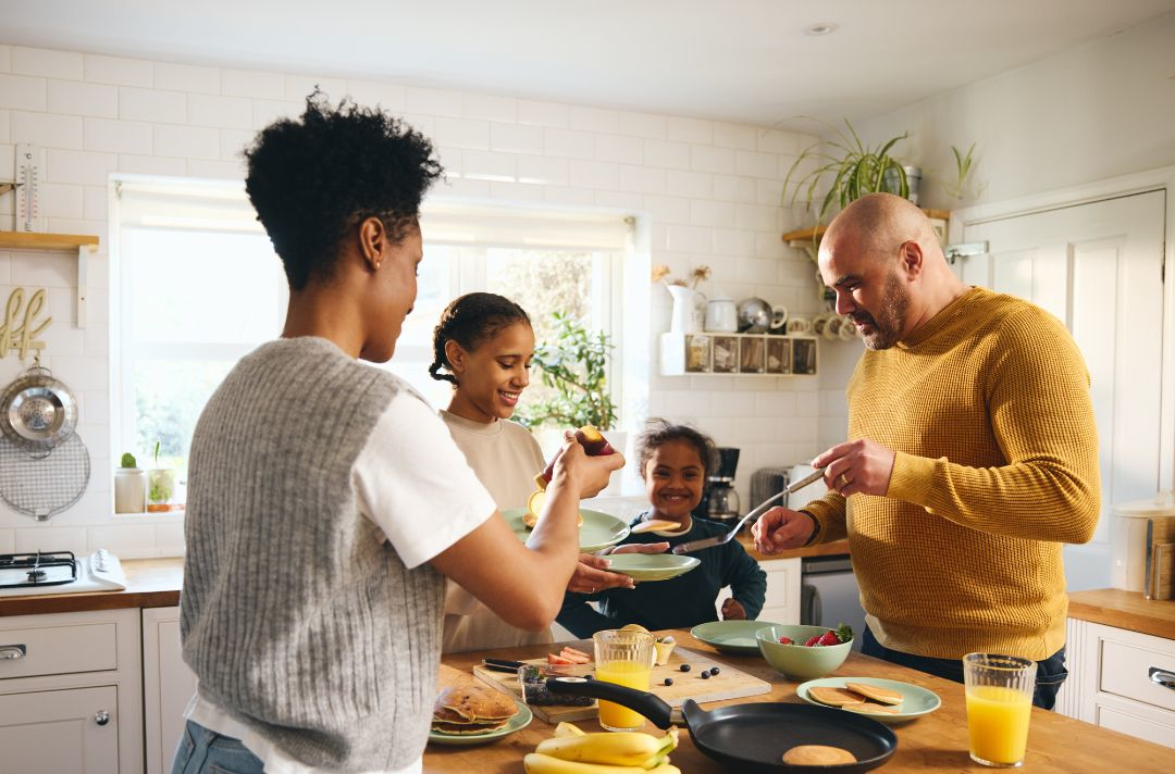 A photo of a family making pancakes