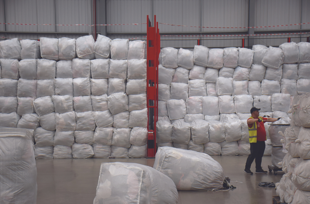 A photo of bags of processed textiles at recycling site