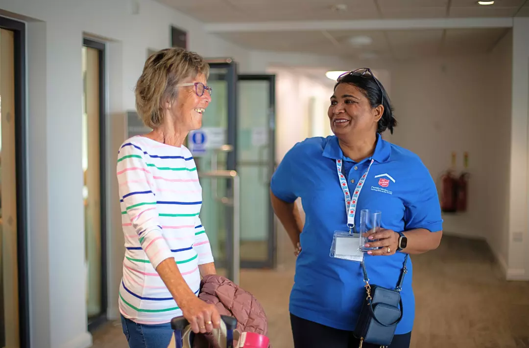 A photo of two people in conversation at Riverbank 2023.