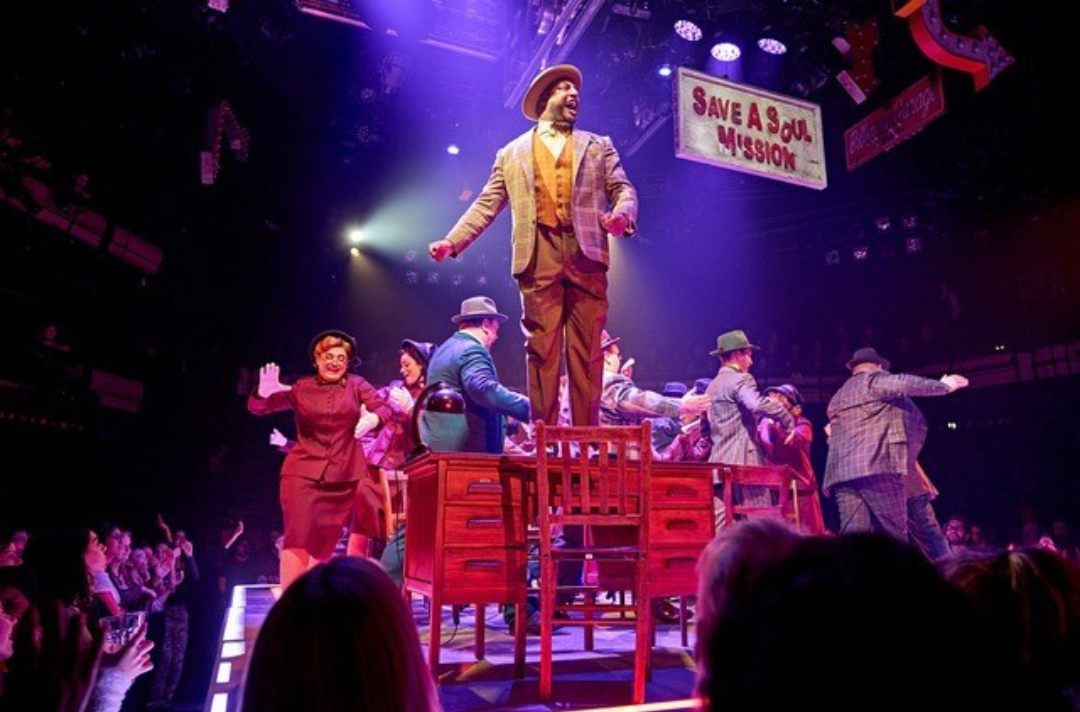 A photo of the cast performing in Guys and Dolls