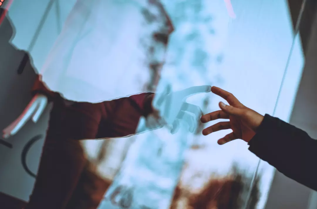 A photo shows someone touching a window.