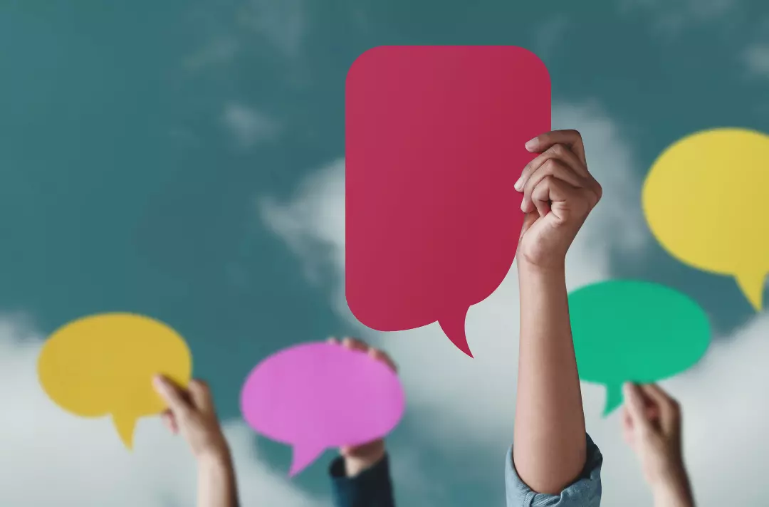 A photo shows people holding up colourful speech bubbles.