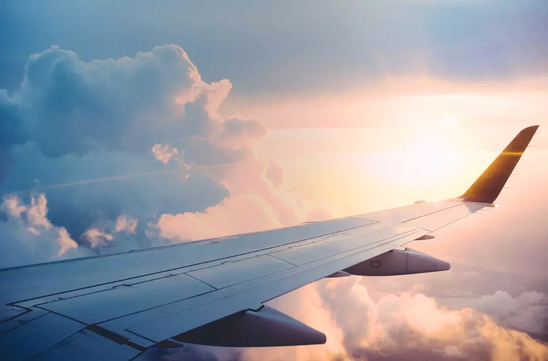 A photo shows the wing of an aeroplane in flight.