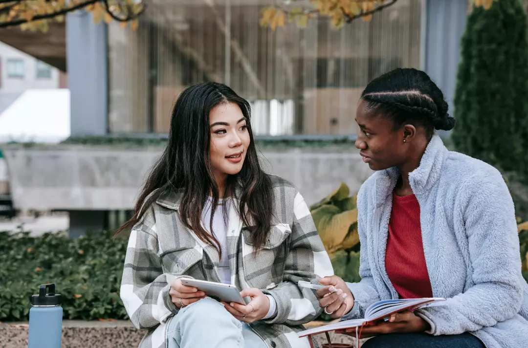 A photo shows two people in conversation.