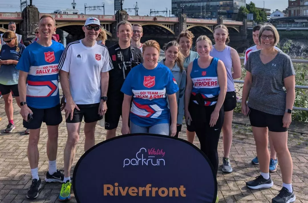 A group of people in running gear, some with Salvation Army red shield branding