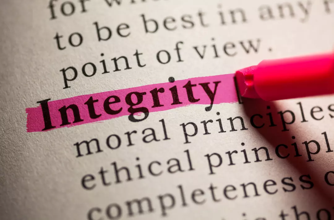 A photo shows a book with the word 'integrity' highlighted in pink.