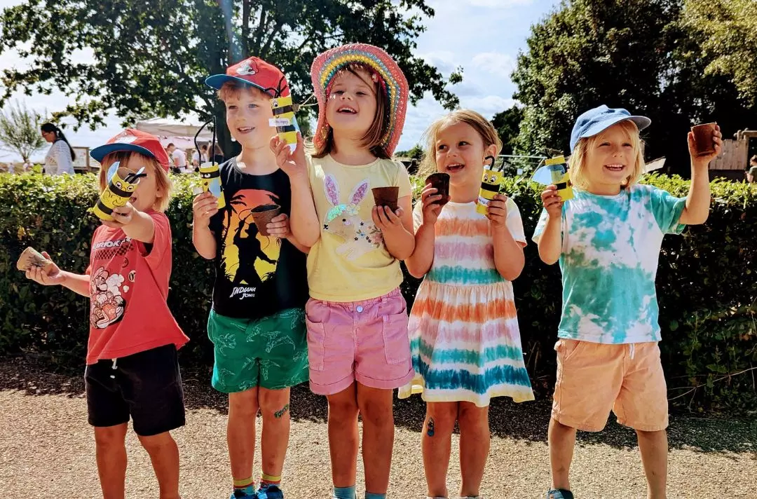 A photo of children with their bee crafts at Hadleigh Farm