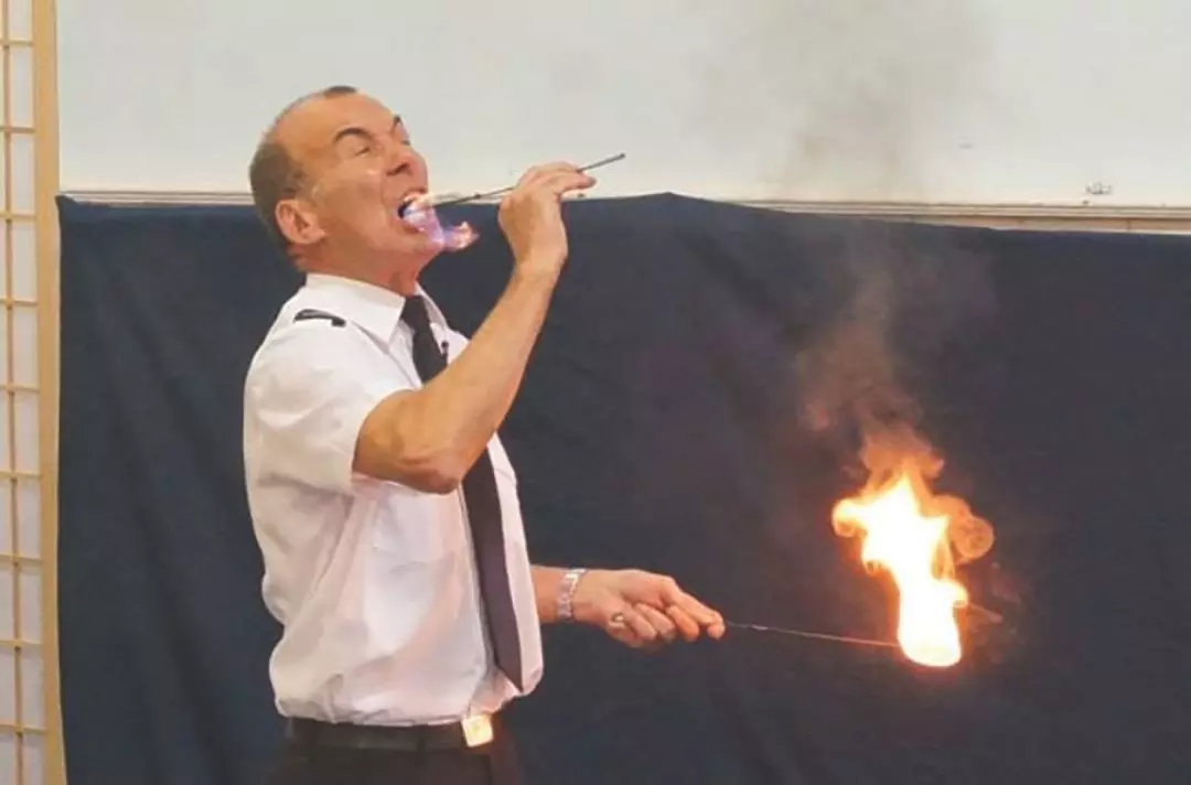 A photo of Ian using fire eating to preach a gospel message