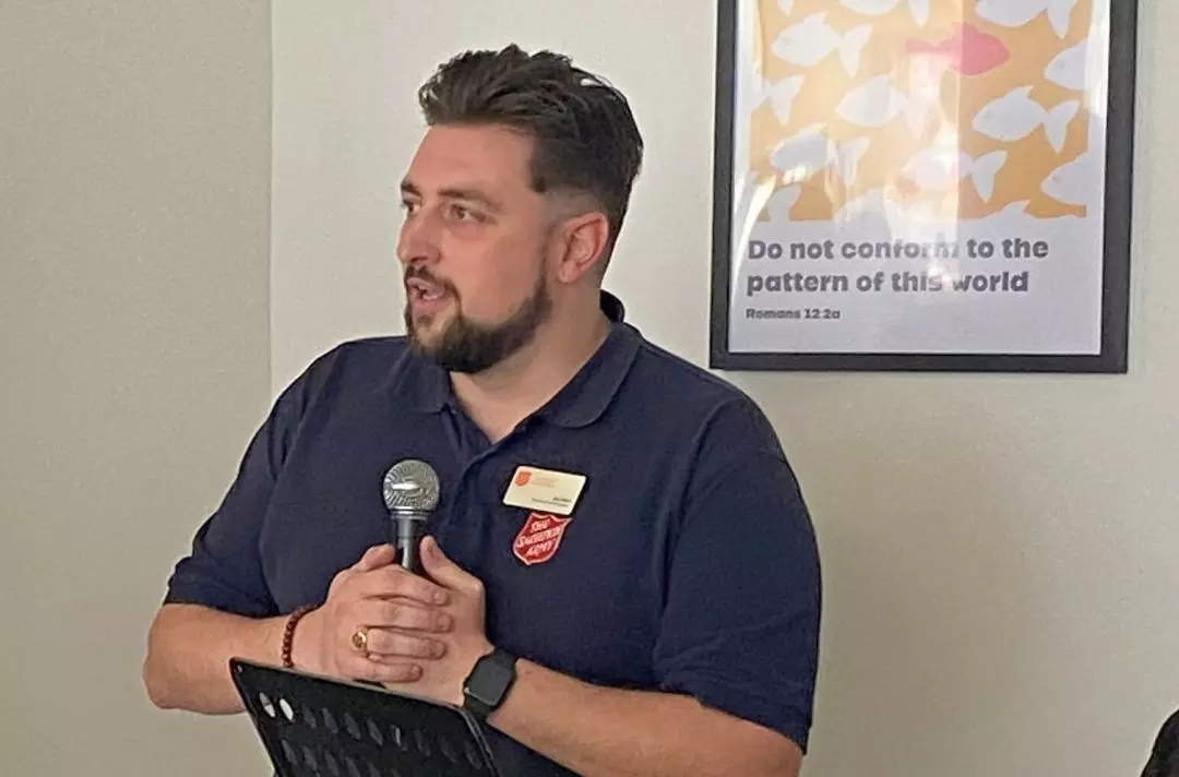 A photo of Jon Munn, a Salvation Army leader, speaking into a microphone