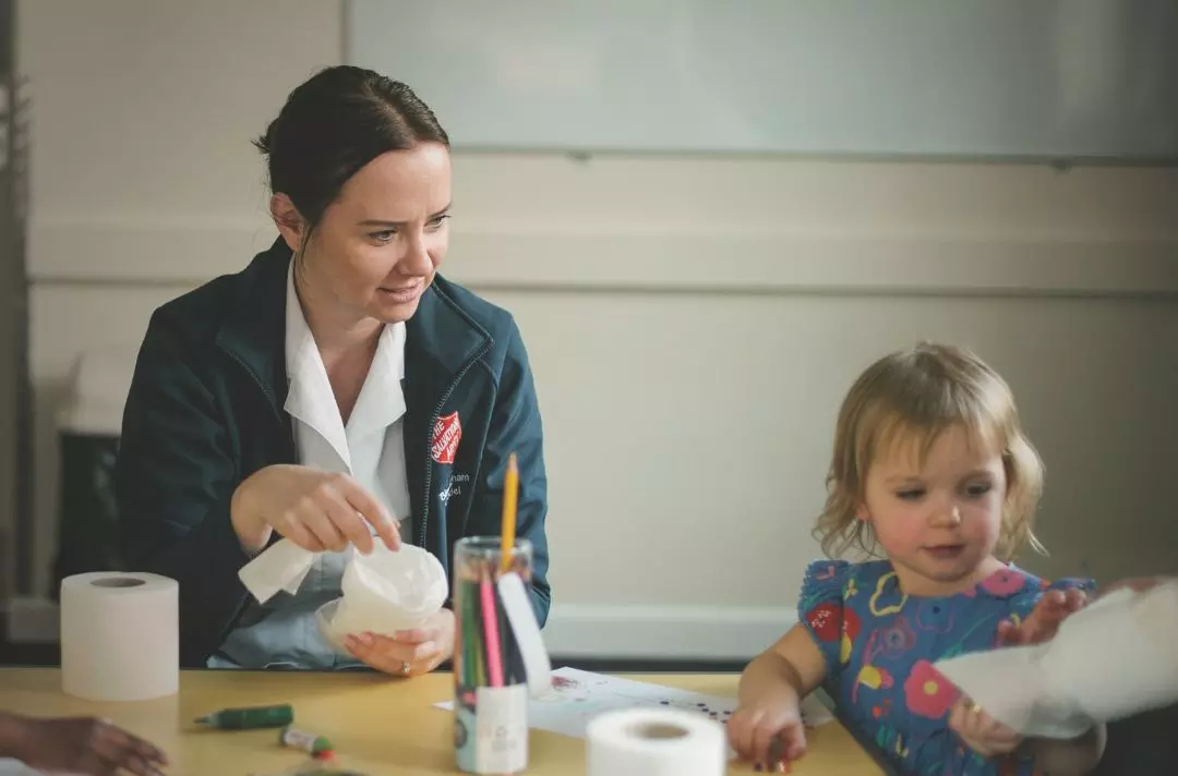 A photo of an Salvationist with a child