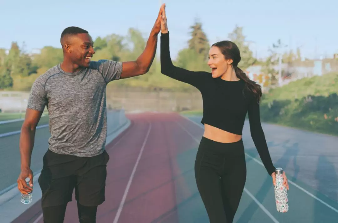 A photo of two people high-fiving