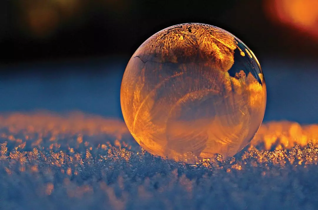 A marble of light on frosty ground