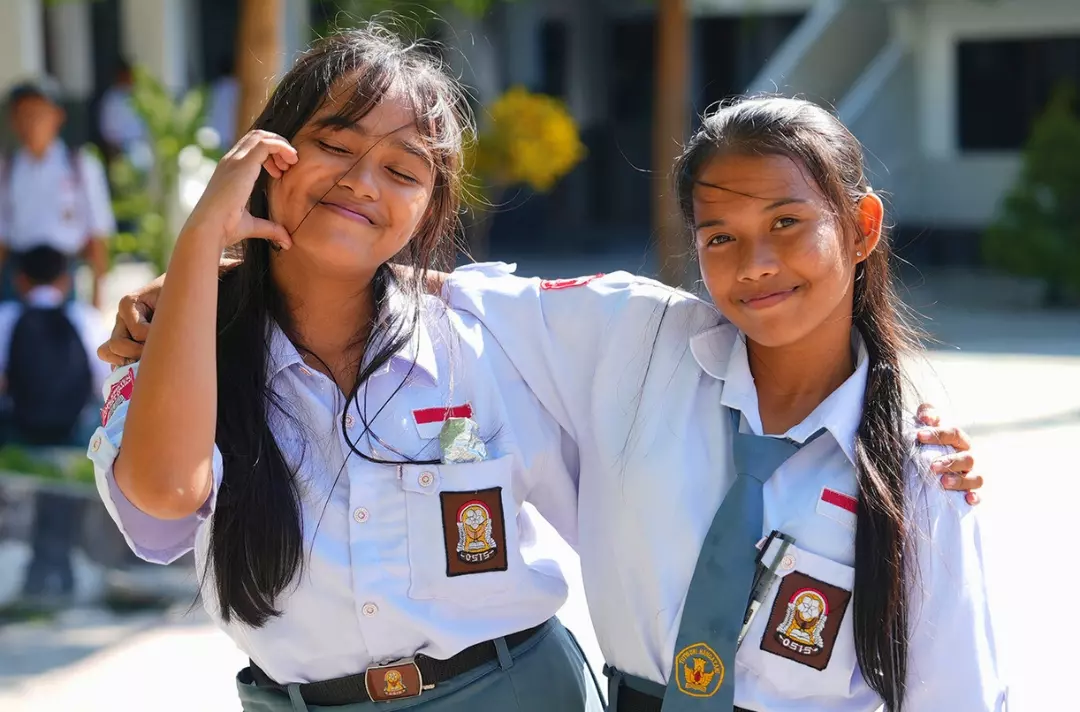 A photo shows two young people from Indonesia posing for the camera.
