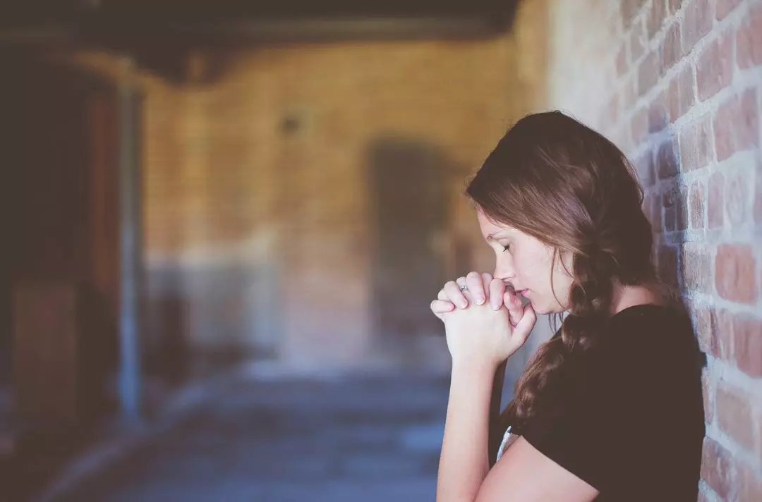 A young woman praying