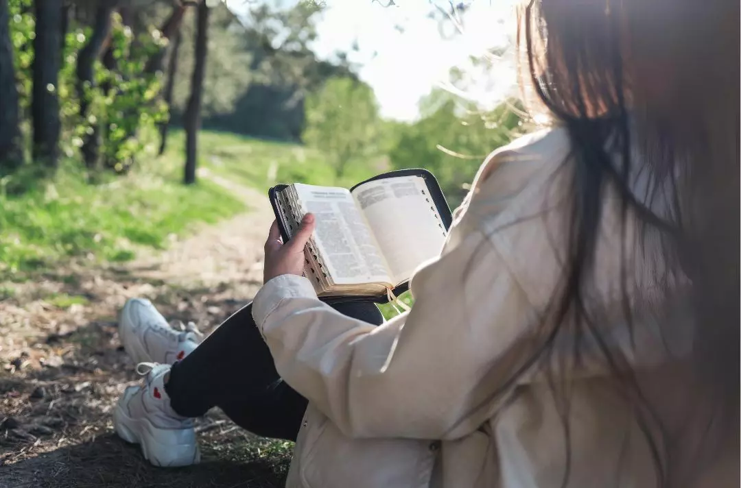 A photo of a girl reading a Bible
