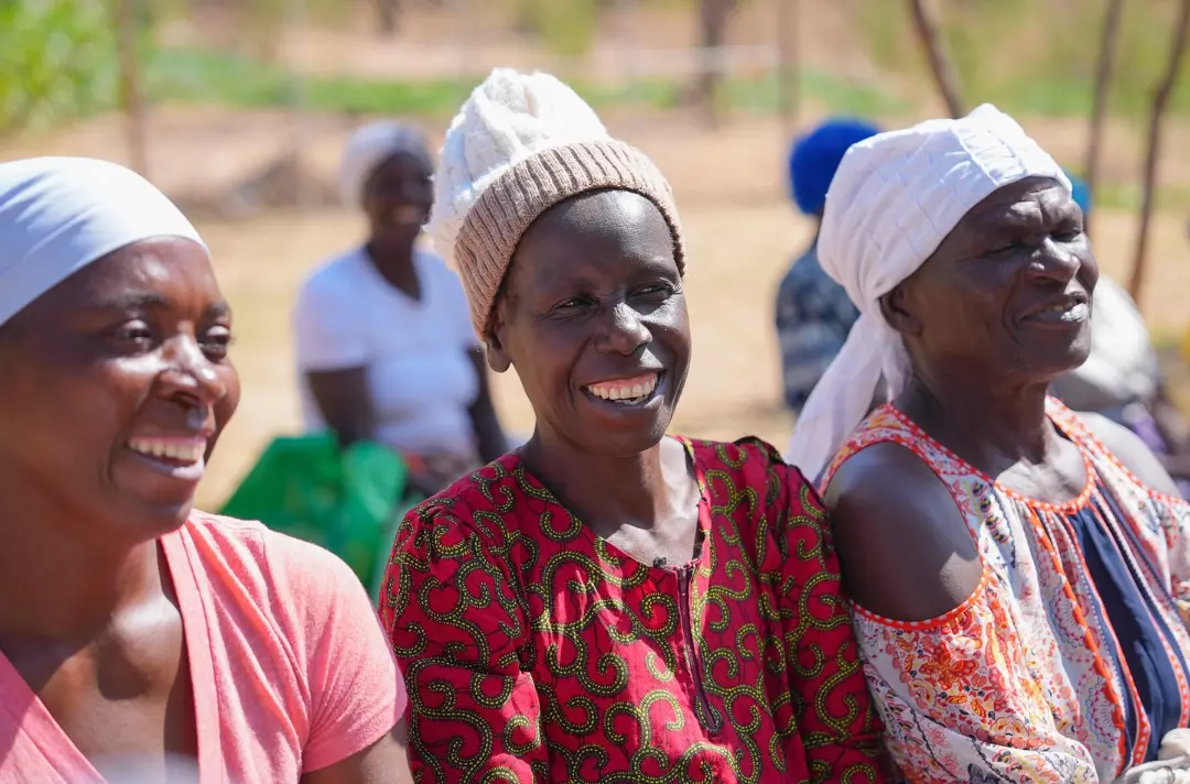 A photo shows three smiling people.