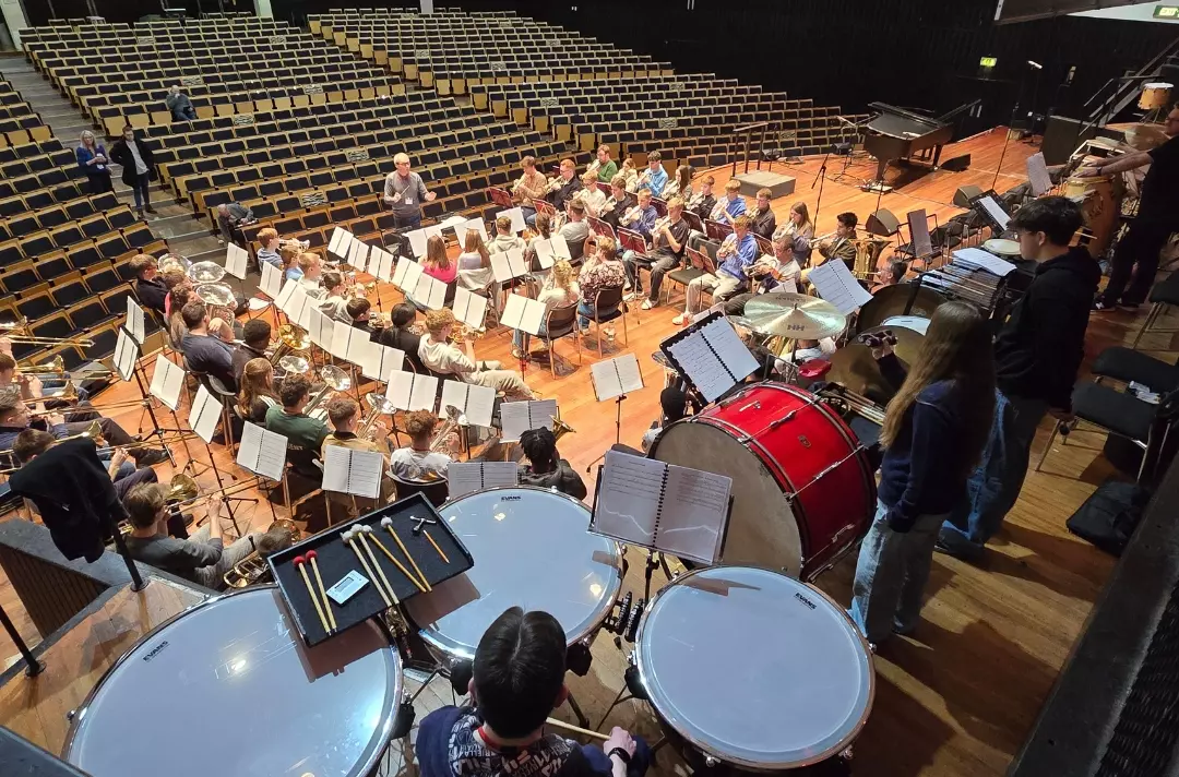A photo shows TYB rehearsing.