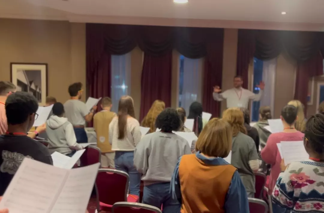 A photo shows TYC rehearsing.
